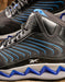 side of the shoe featuring mesh and microfiber uppers in both black and blue