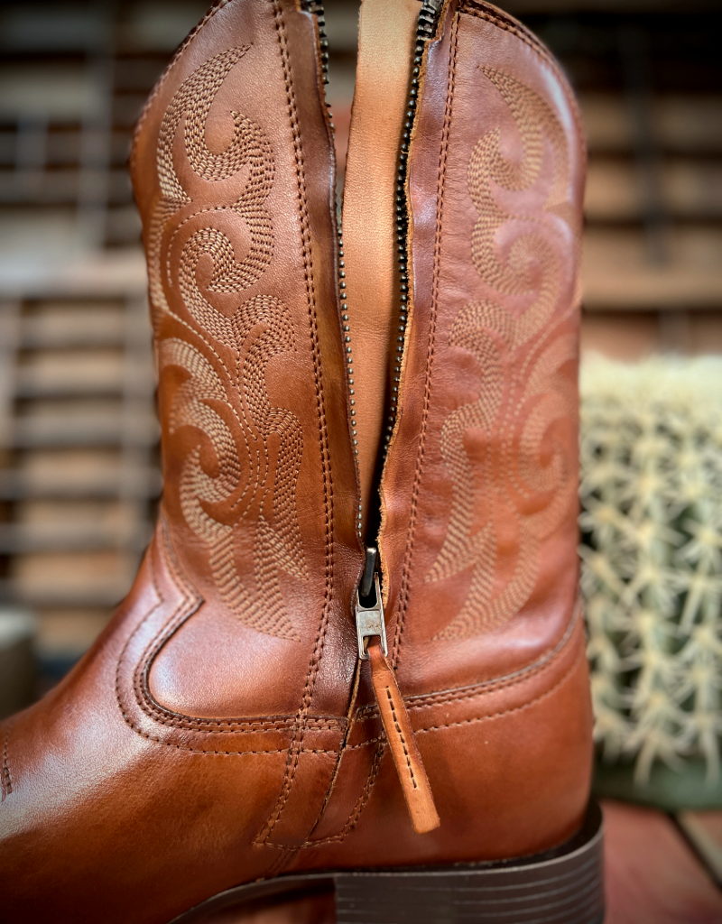 Close-up of a brown leather boot shaft with intricate western stitching and a zipper.
