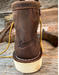 Brown leather boot with 'Danner' branding on a wooden surface