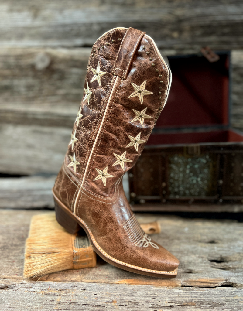 Brown cowboy boot with star patterns on a wooden surface