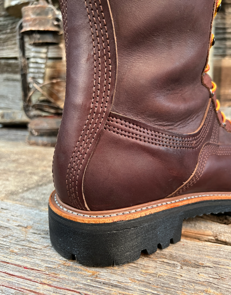 Close-up of a brown leather boot with black sole on a wooden surface