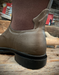 Brown rubber boot on a wooden floor