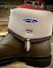 Brown boot with a beige lining, featuring the Xpress Cool logo, on a wooden surface.