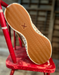 Tan shoe sole with a Twisted X brand logo on a red chair