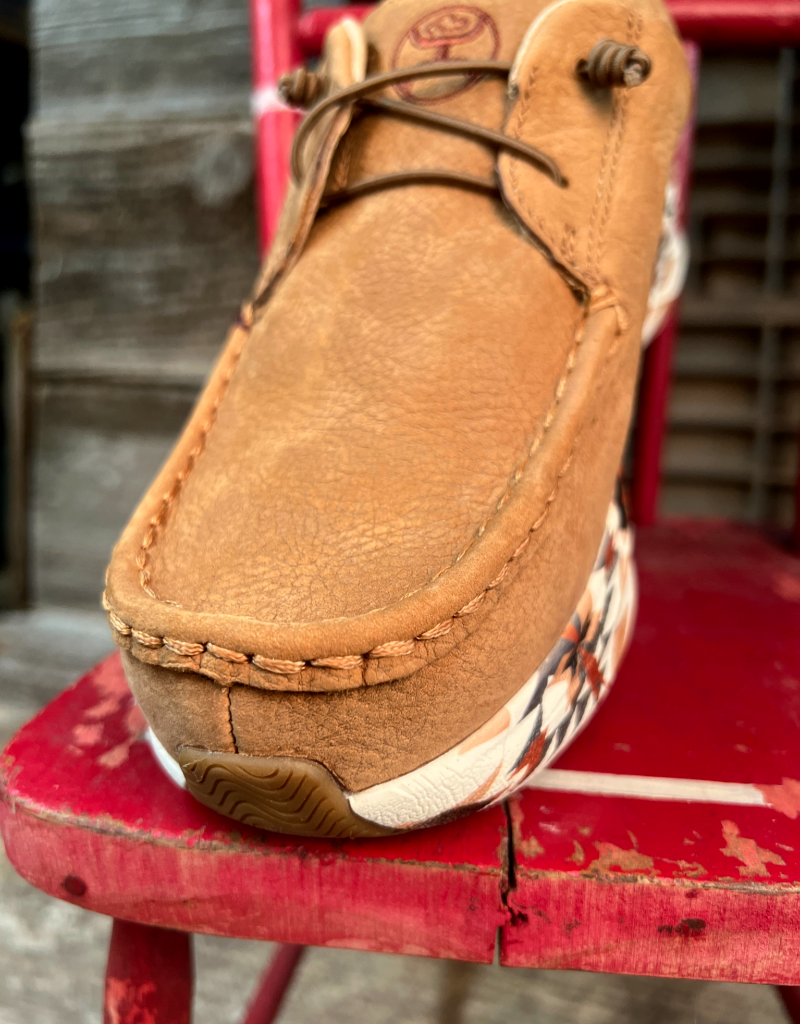 Brown leather shoe with a patterned sole on a red chair
