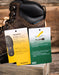 Brown work boot with Treadfast and 4LR features tags on a wooden surface