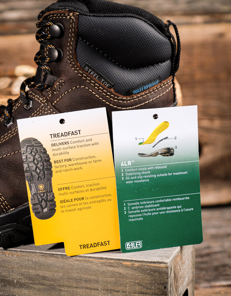 Brown work boot with Treadfast and 4LR features tags on a wooden surface