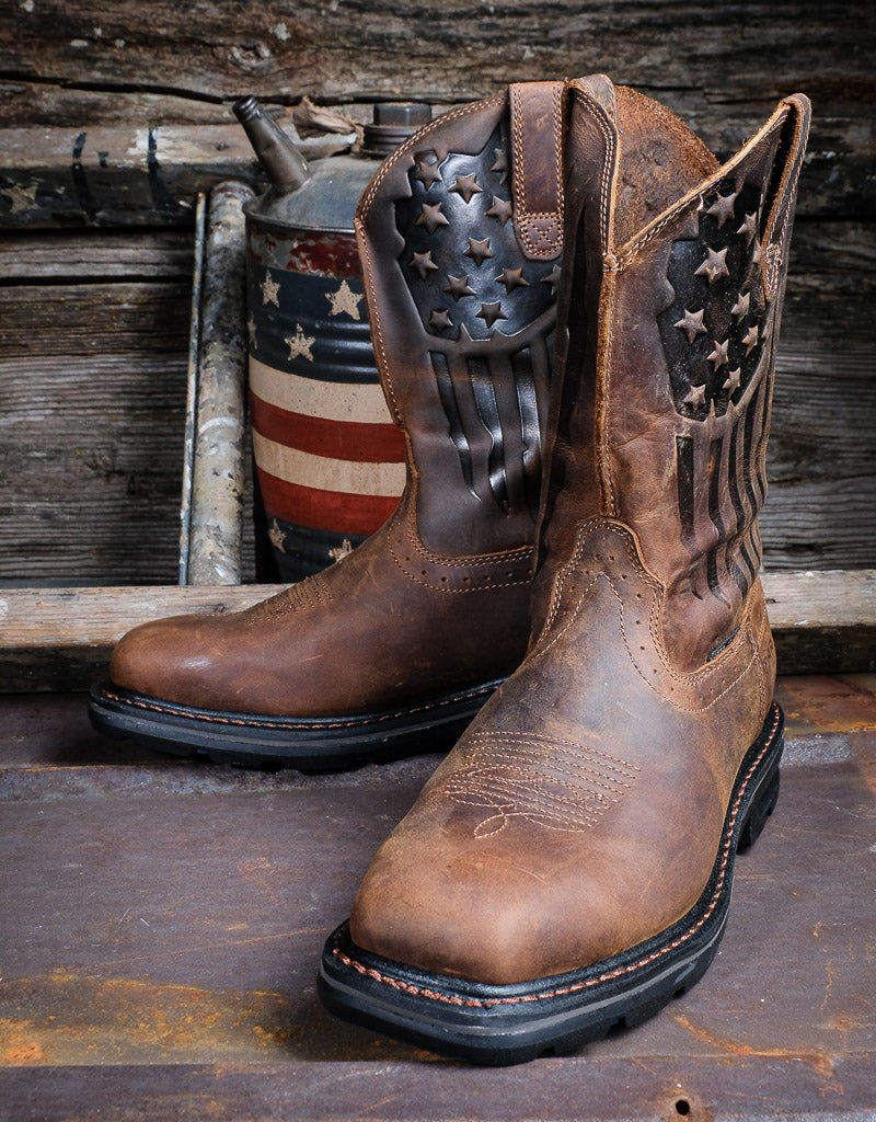A pair of Ariat men's work boots with full-grain leather and a patriotic stars and stripes design on the shaft, featuring a steel toe cap.