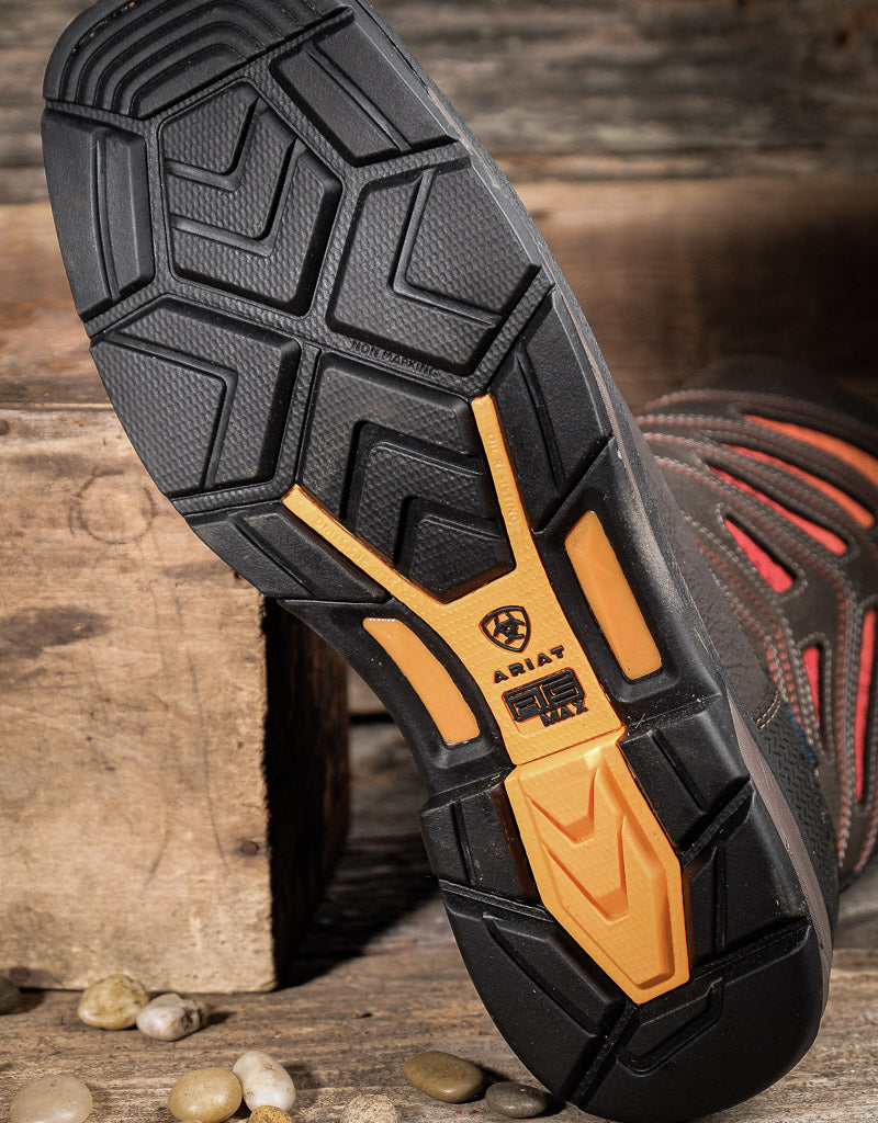 Close-up of a Ariat boot Workhog XT sole with a brand logo on a wooden background