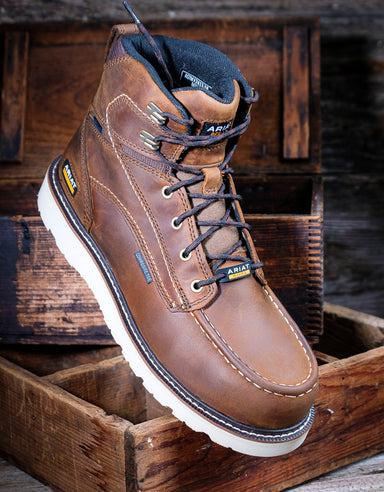 Brown leather boot with white sole on a wooden background