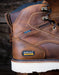 Brown leather work boot with Ariat branding on a blurred background