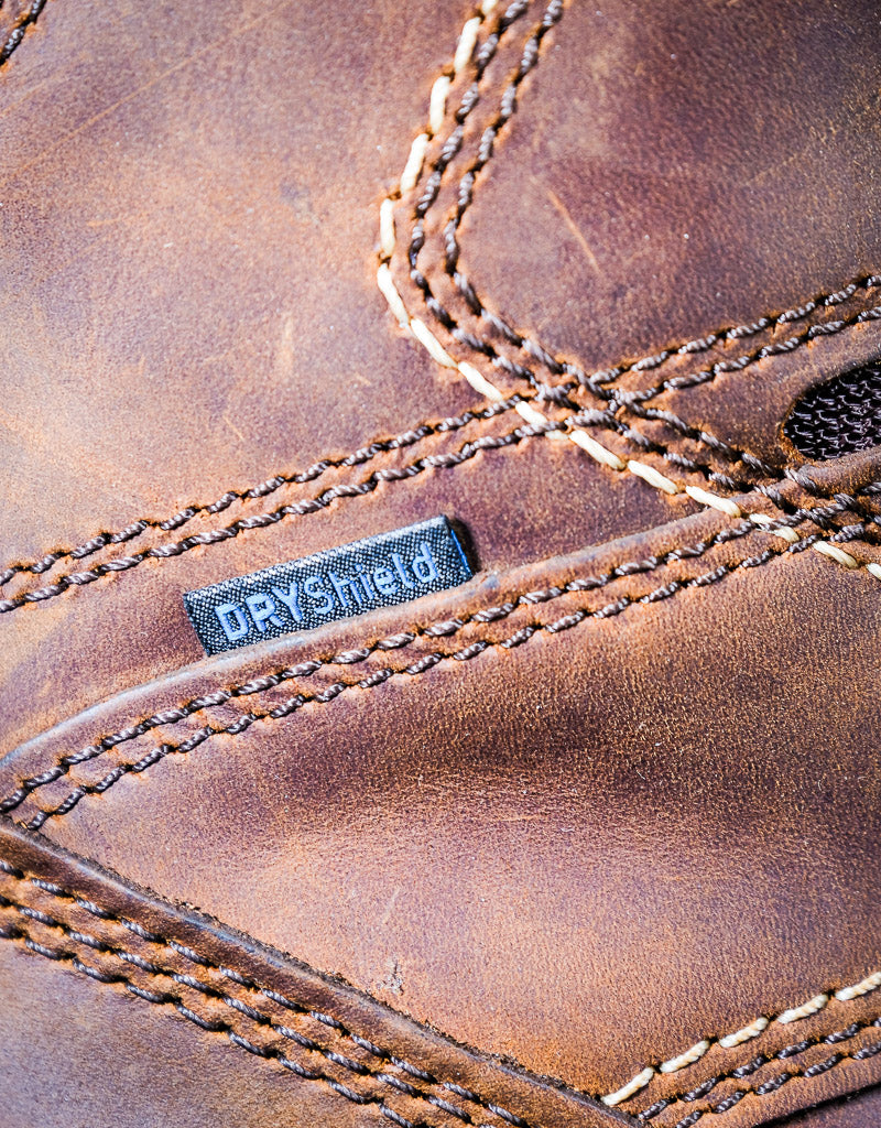 Close-up of a brown leather boot with 'DryShield' label