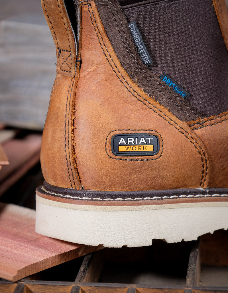 Brown work boot heel with Ariat label on a wooden surface