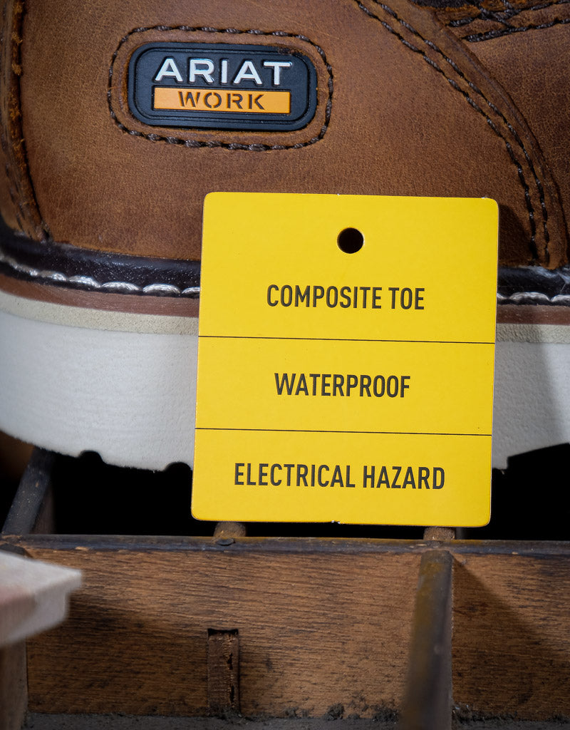Brown work boot with Ariat label and a yellow tag indicating features like composite toe, waterproof, and electrical hazard protection.