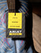 Ariat work boot with a label indicating steel toe, waterproof, and electrical hazard protection features on a blue embroidered boot shaft.