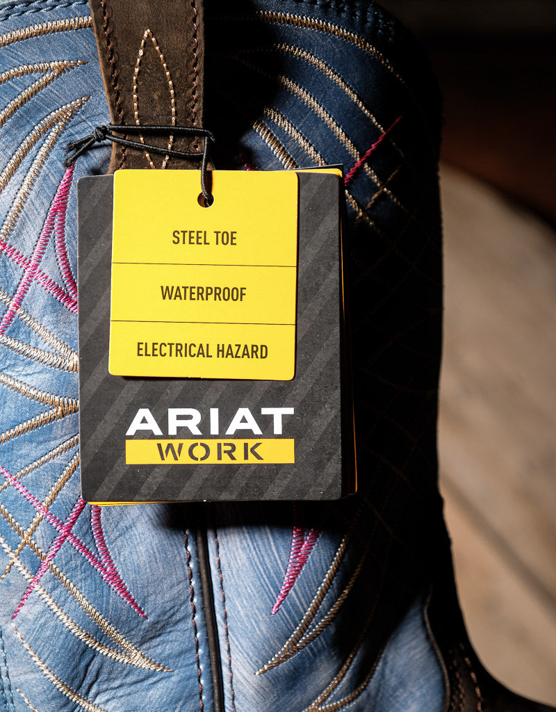 Ariat work boot with a label indicating steel toe, waterproof, and electrical hazard protection features on a blue embroidered boot shaft.