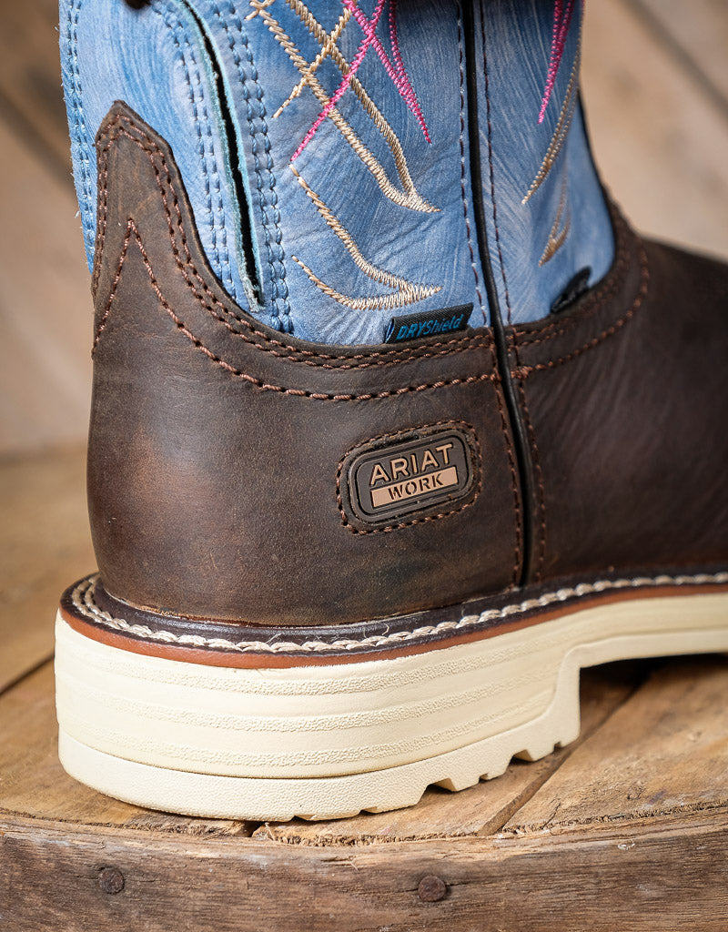 Brown leather boot with blue shaft on a wooden surface, featuring the Ariat logo.