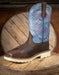 Brown and blue cowboy boot on a wooden surface