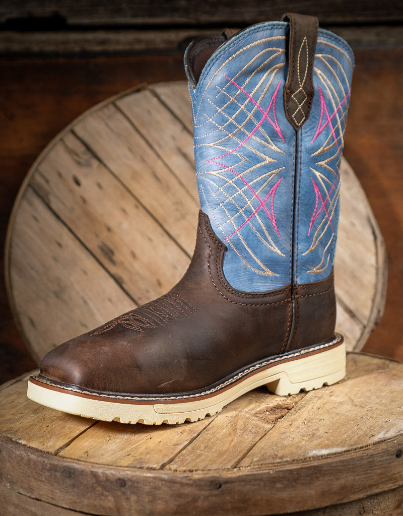 Brown and blue cowboy boot on a wooden surface