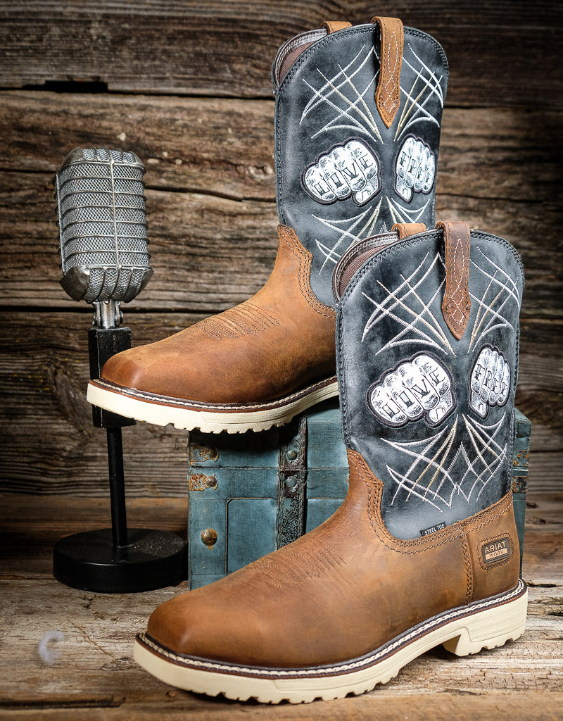 Brown work boots with decorative inlays on a wooden background