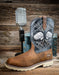 Brown cowboy boot with decorative top next to a microphone on a wooden background