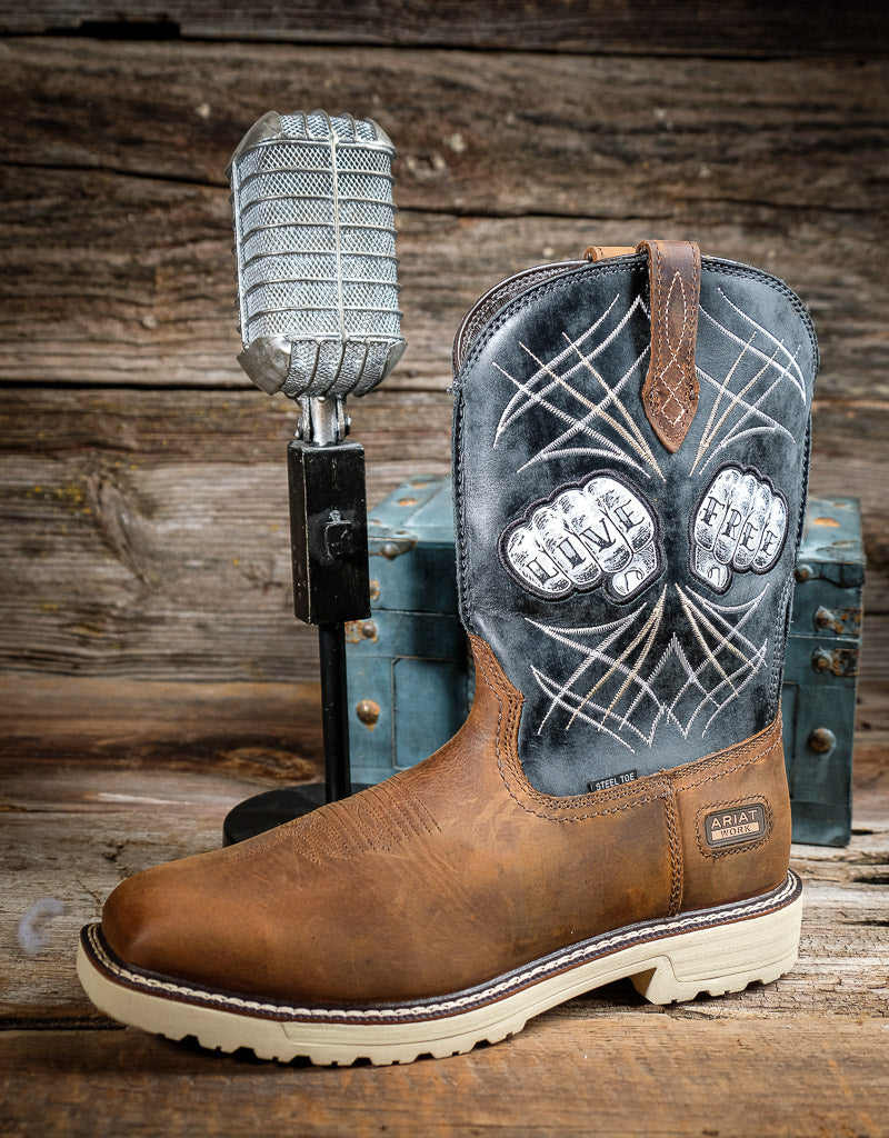 Brown cowboy boot with decorative top next to a microphone on a wooden background
