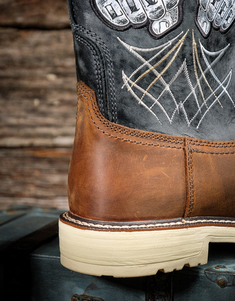 Close-up of a boot with detailed stitching and leather finish against a wooden background