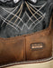 Close-up of a brown leather boot with intricate stitching and Ariat Work logo.