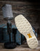 Microphone and boot with a off-white sole on a wooden surface