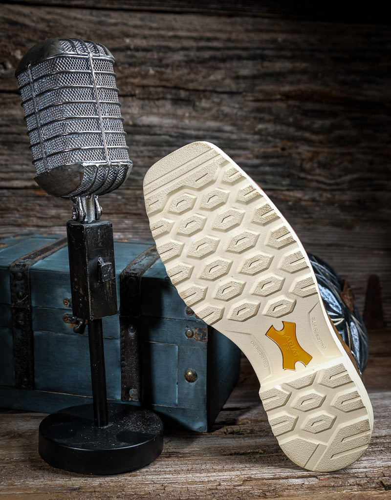Microphone and boot with a off-white sole on a wooden surface