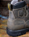 Close-up of a Carolina work boot on a rustic background