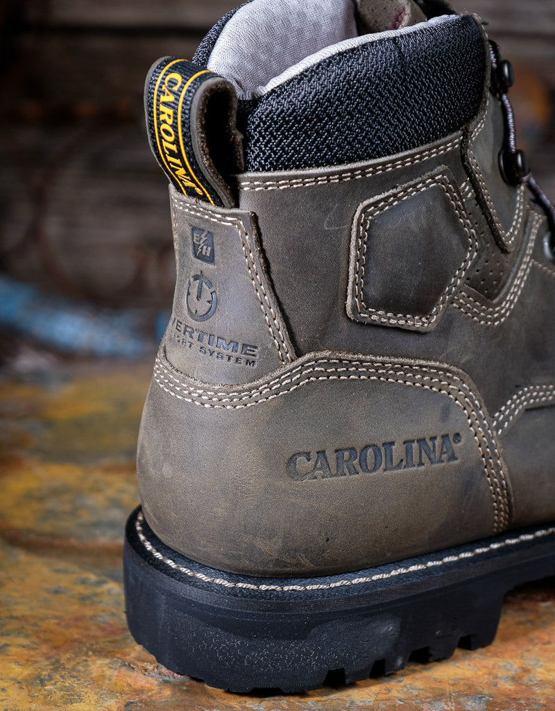 Close-up of a Carolina work boot on a rustic background