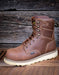 Brown leather boot with visible brand logo on a wooden background