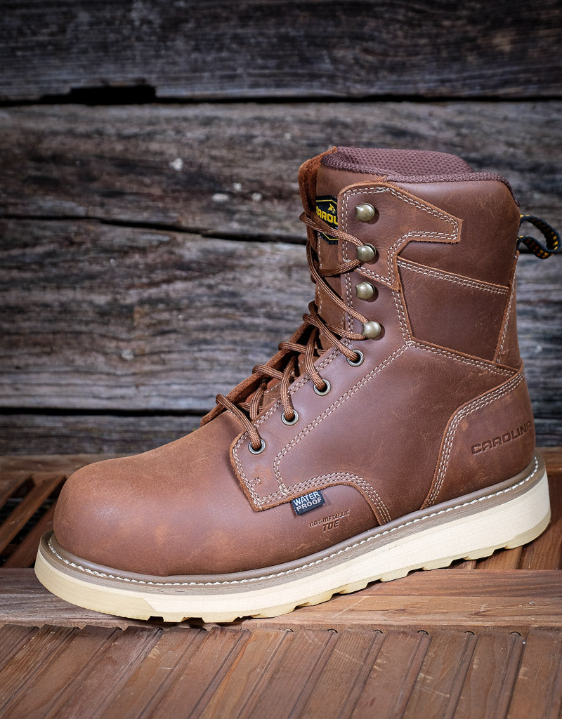 Brown leather boot with visible brand logo on a wooden background