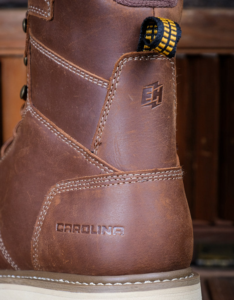 Brown leather boot with 'Carolina' branding and 'EH' label on a blurred background