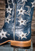 Blue cowboy boot with star patterns on a wooden surface