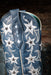 Blue cowboy boot with silver star and moon designs on a dark background