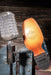 Shoe sole with a Corral brand logo next to a vintage microphone on a wooden background