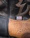 Close-up of a leather boot with intricate stitching and an American flag patch.