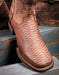 Close up on the square toe of western boot and the snake print 