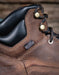 Close-up of a brown leather boot with laces and a label saying Danner Dry waterproof on a blurred background