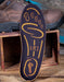 Blue and yellow insole with brand logo on a wooden bench