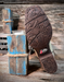 Close-up of a boot sole with 'Justin' branding on a rustic wooden background