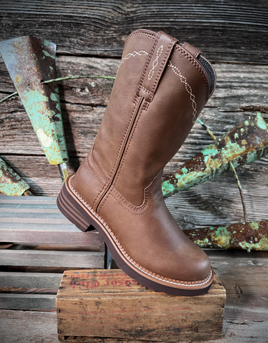 Brown leather boot on a wooden block with rustic background