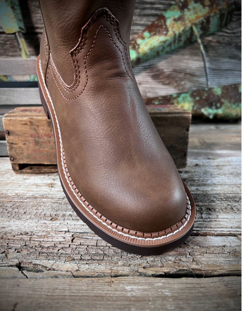 Brown leather boot on a rustic wooden surface