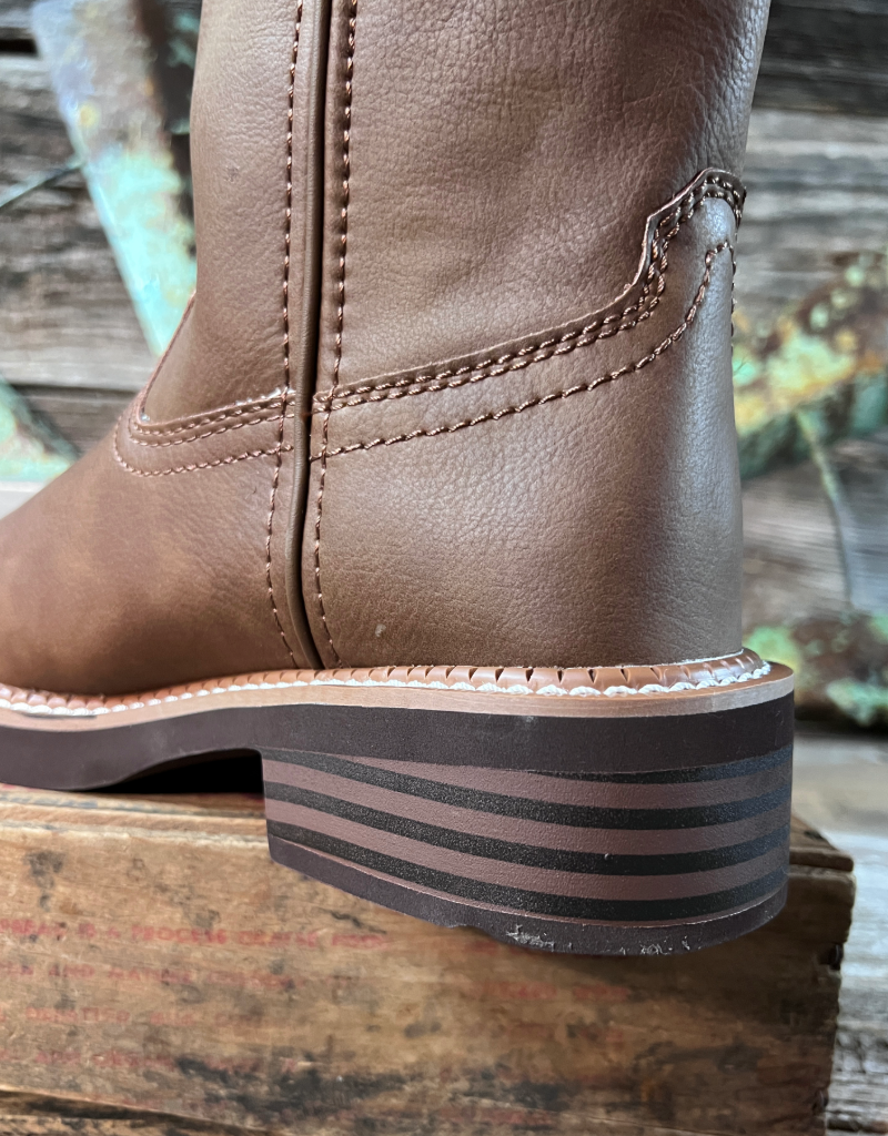 Brown leather boot with a thick sole on a wooden surface