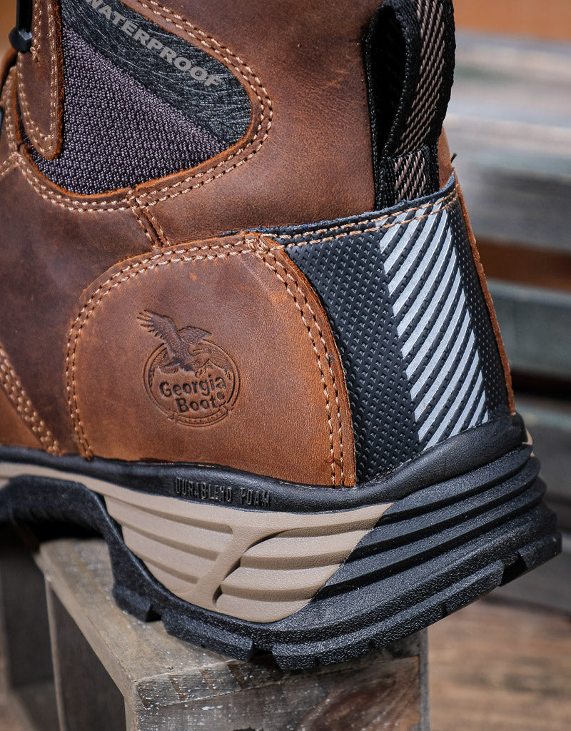 Brown boot with Georgia Boot logo on a wooden surface