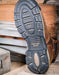 Close-up of a black boot sole with a Georgia Boot label on a wooden surface.