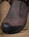 Brown slip-on shoe with black sole on a burlap background