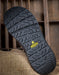 Close-up of a black sole with a yellow KEEN logo on a textured surface.